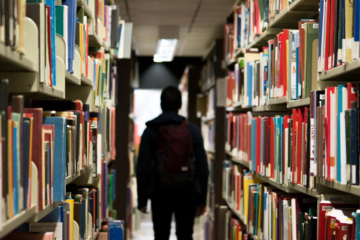 Student walking through a library